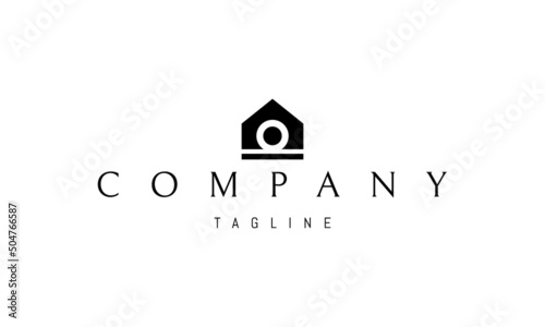 Vector logo on which an abstract image of a house and an omega symbol inside.
