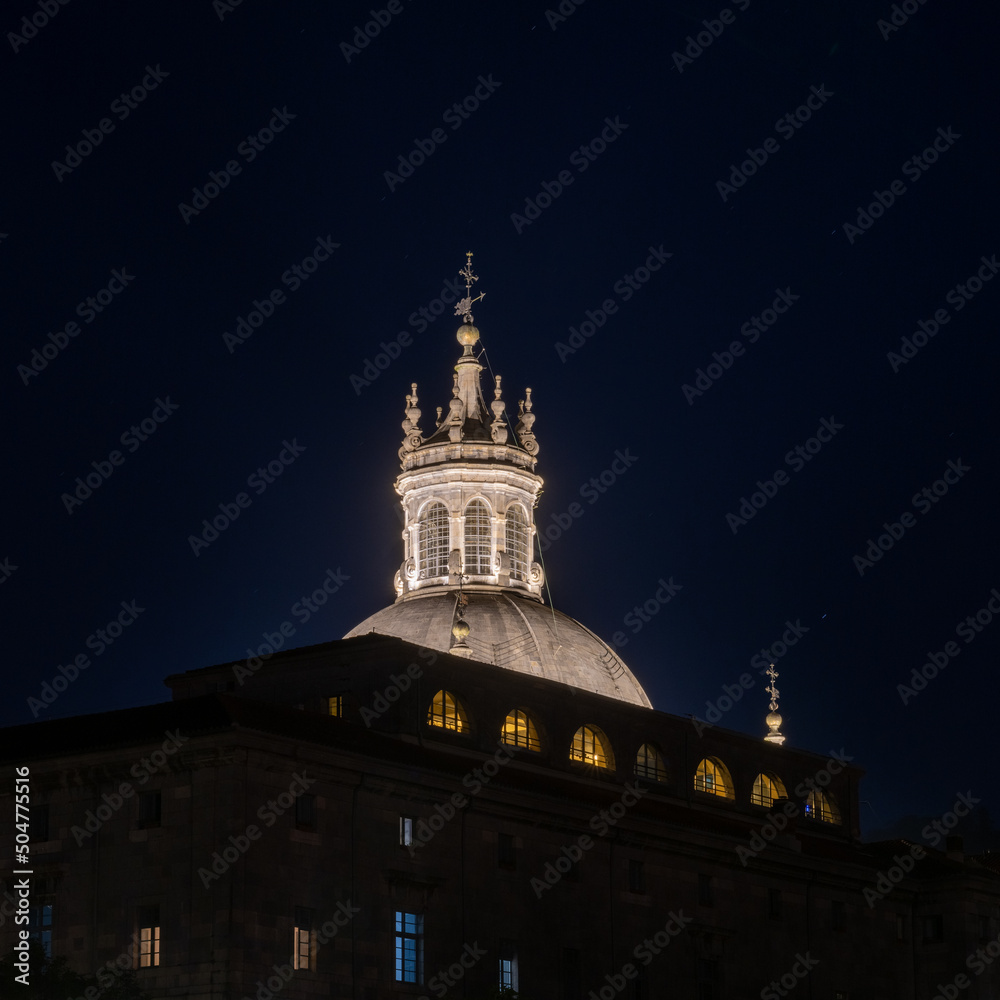 nighttime view of the illuminated cupola and basilica of Saint Ignatius of Loiola