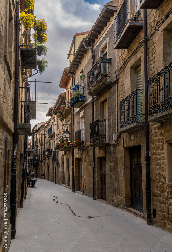 narrow picturesque street with brown stone buildings in the historic city center of Laguardia in La Rioja