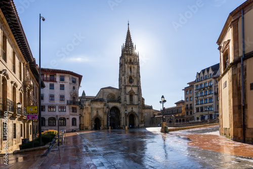 horizontal view of the San Salvador Cathedral and square in the historic city center of Oviedo with a sunburst © makasana photo