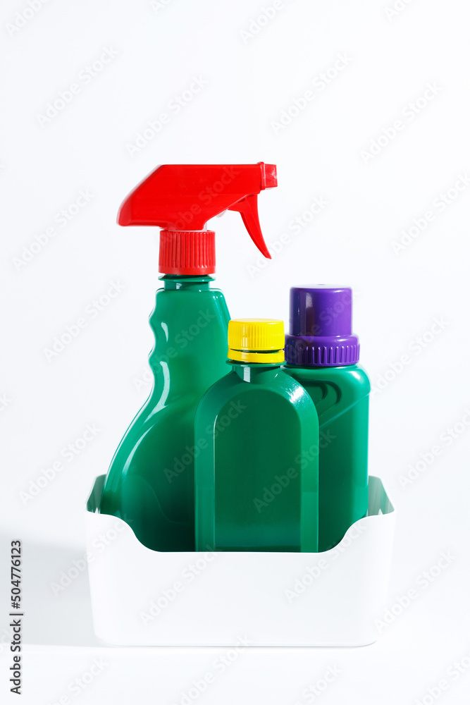 Bottles and spray of garden products and fertilizers for growing plants. Isolated on white background.vertical photo Bottles and spray of garden products and fertilizers for growing plants. Isolated on white background.vertical photo