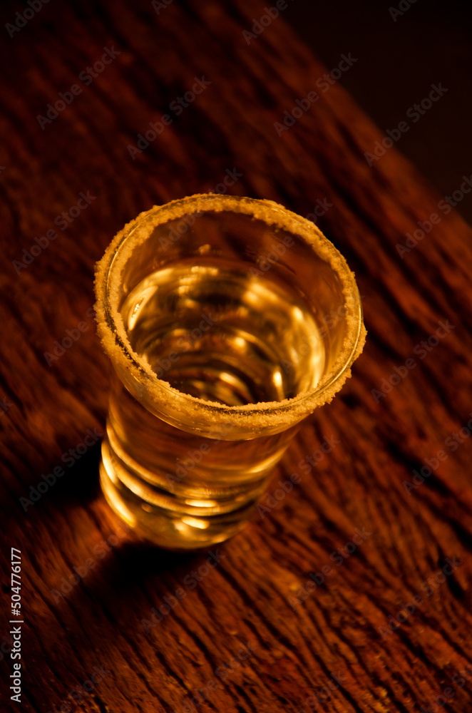 Glass of caipirinha, with the rim decorated with salt, accompanied by lemon and a wooden tray. Alcoholic beverage Glass of caipirinha, with the rim decorated with salt, accompanied by lemon and a wooden tray. Alcoholic beverage