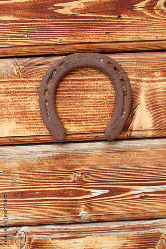 antique horseshoe on wooden background