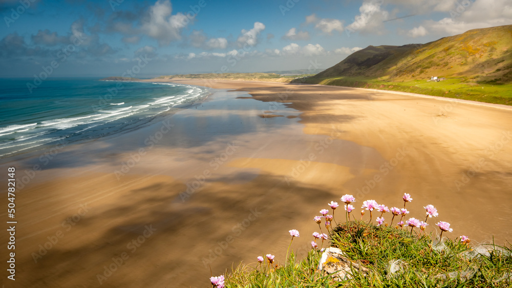 Fototapeta premium Summer sky warm day in Rhossili beach south wales view over the ocean