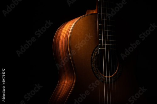 Classical guitar on a black background with copy space