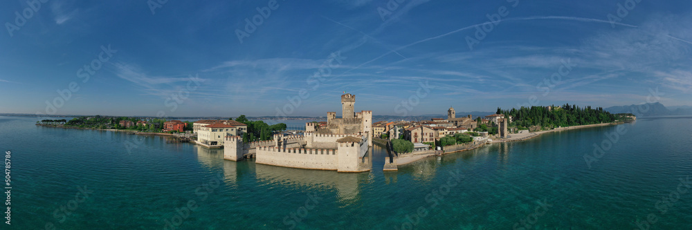Aerial photography with drone, Rocca Scaligera Castle in Sirmione. Garda, Italy. Popular travel destination on Lake Garda in Italy. Scaligero Castle panorama drone view. Sirmione top view.