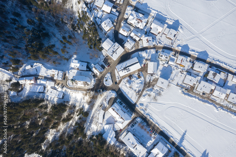 Fototapeta premium Aerial View of Itter Traditional Austrian village Covered by Snow in Winter Morning.
