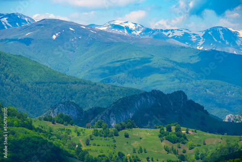 Green forest and snow-capped mountains. Valleys and mountains.