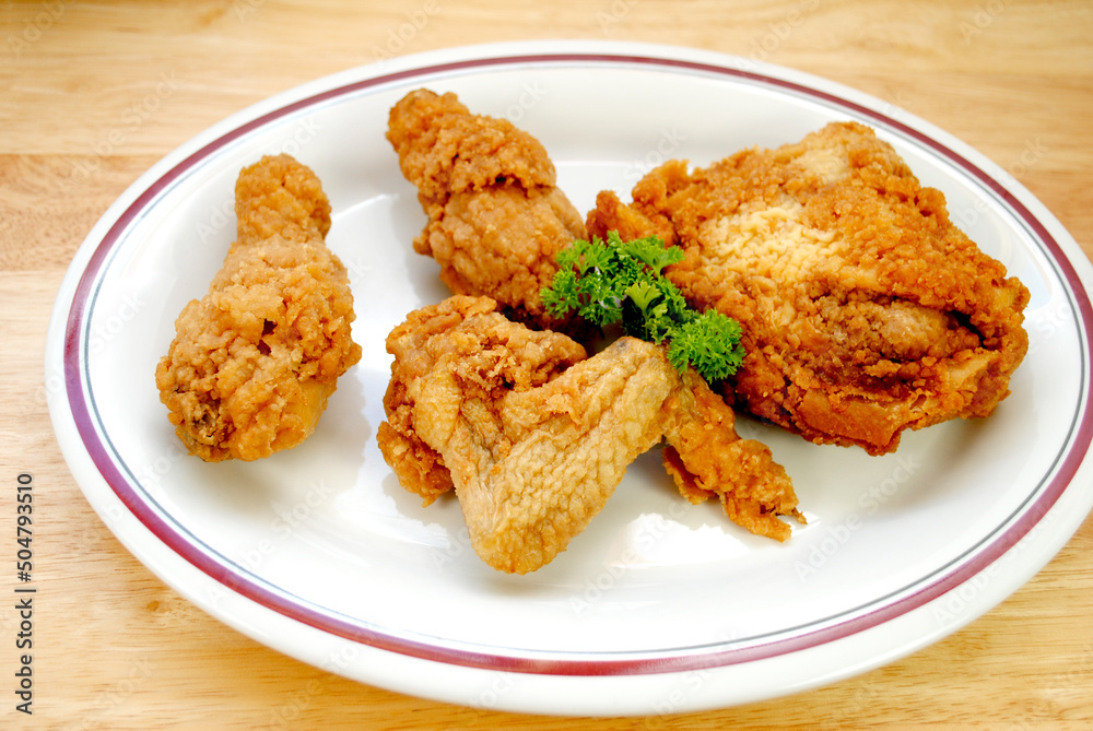 Fried Chicken Pieces Served on a White Plate Fried Chicken Pieces Served on a White Plate