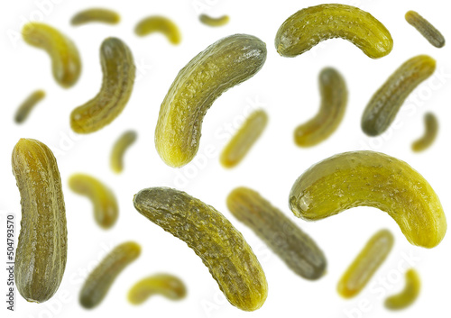 Marinated pickled cucumbers isolated on a white background, selective focus. Falling gherkins.