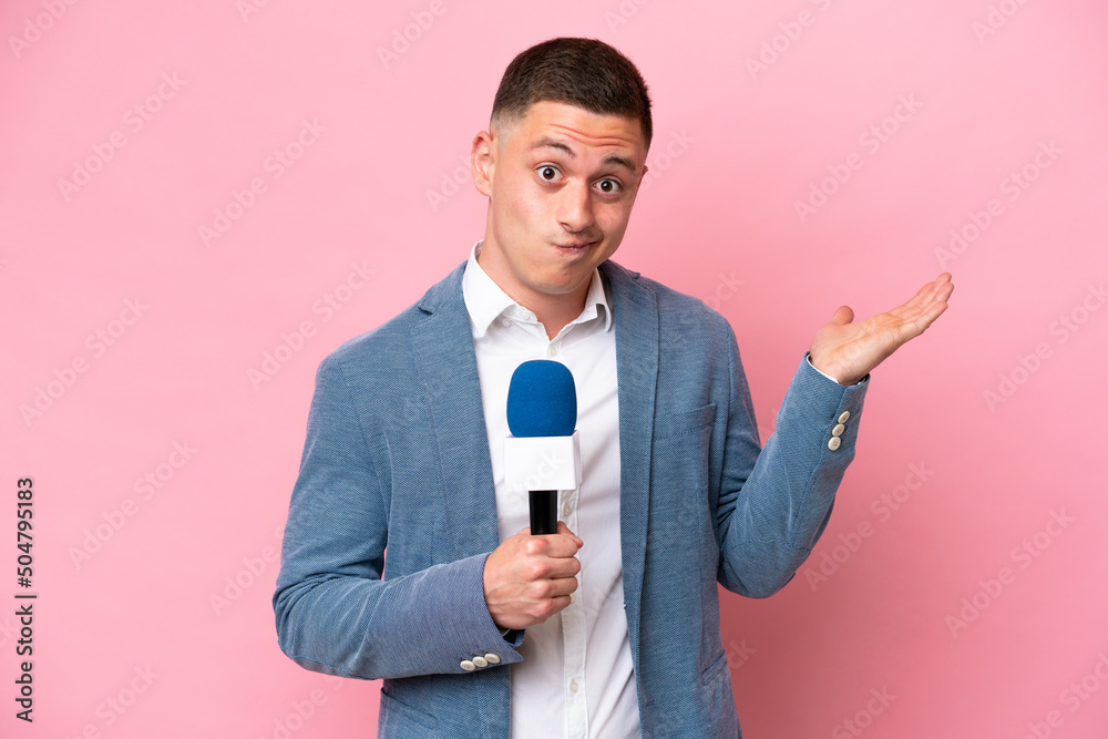 Young brazilian presenter man isolated on pink background having doubts while raising hands - obrazy, fototapety, plakaty 