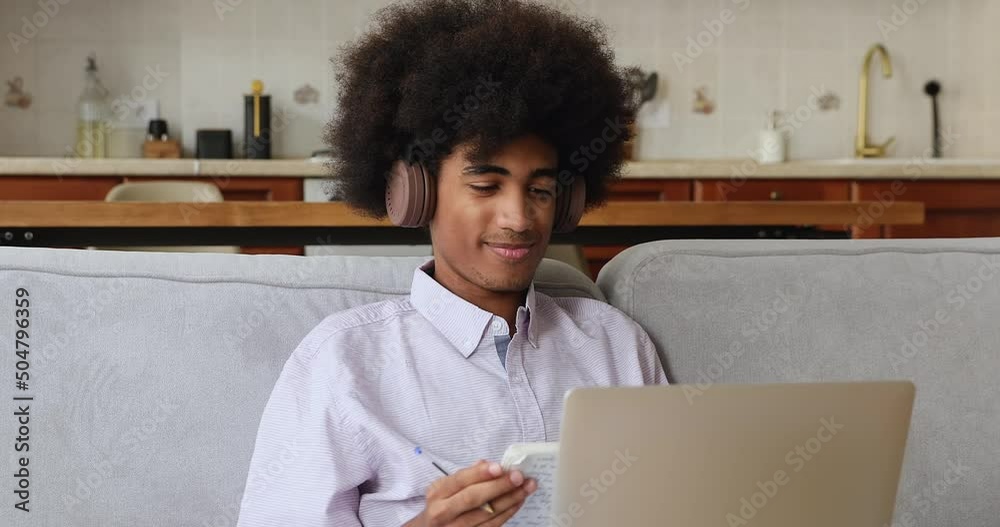 Smiling Black male teacher in headset lead consultation via laptop explain correct problem solution to student in videochat. Young guy freelancer express point of view on virtual meeting with partner Smiling Black male teacher in headset lead consultation via laptop explain correct problem solution to student in videochat. Young guy freelancer express point of view on virtual meeting with partner