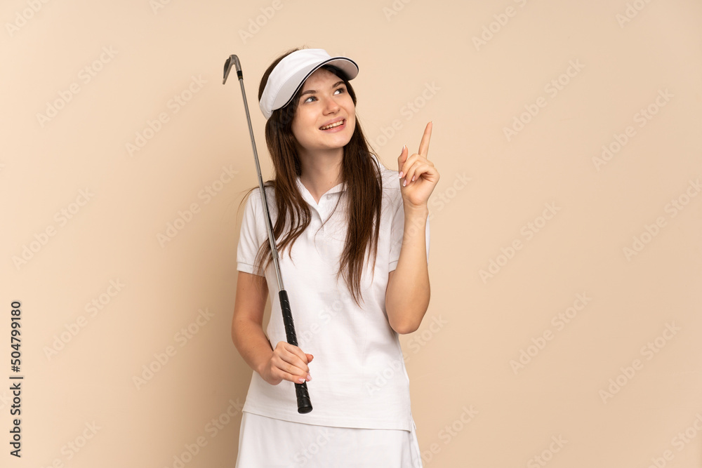 Young Ukrainian golfer girl isolated on beige background pointing up a great idea Young Ukrainian golfer girl isolated on beige background pointing up a great idea
