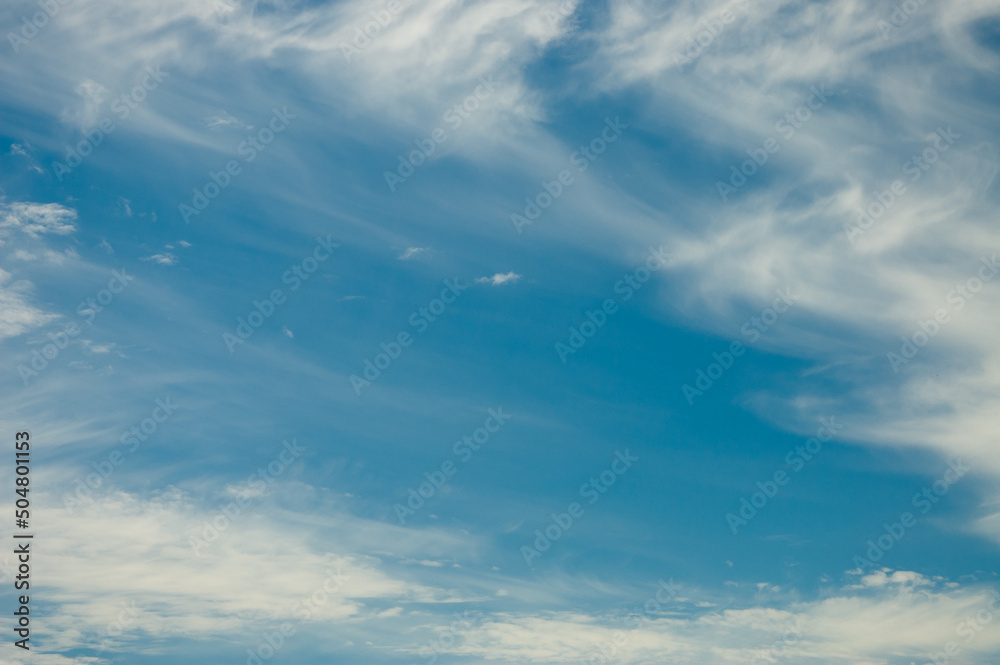 blue sky and clouds, in the photo white clouds on a blue sky background