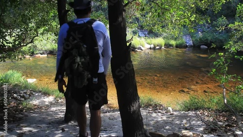 A hiker checks a creek that runs in 800m altitude in central Minas Gerais State, in Brazil photo