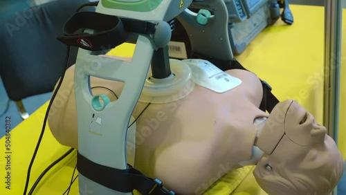 A work of automatic cardiopulmonary resuscitation equipment on a mannequin as a demonstration as well as for education and training of medical personnel. Close up