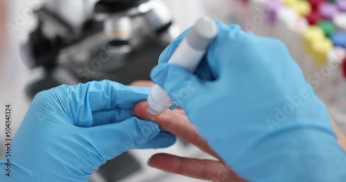 Doctor helps woman check her blood sugar levels with glucometer photo