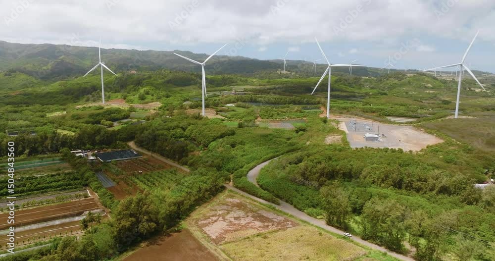 Aerial view of white wind turbines on green hills in Oahu Island, Hawaii Aerial view of white wind turbines on green hills in Oahu Island, Hawaii