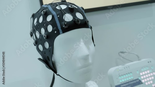 Medical, scientific registration equipment of electroencephalography from the human brain. A special cap with sensors of brain biorhythms and a device that fixes them and records these bioelectrical d photo