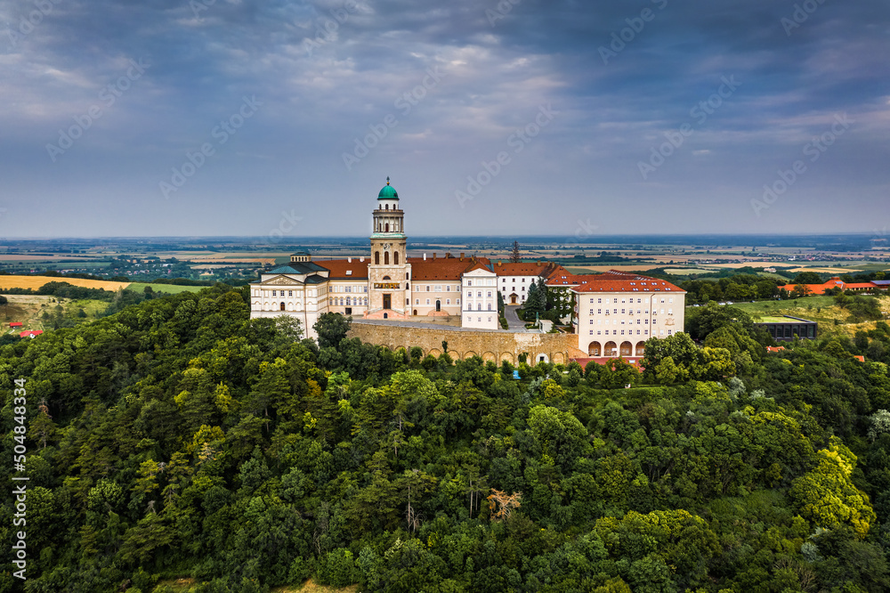 Pannonhalma, Hungary - Aerial view of the beautiful Millenary Benedictine Abbey of Pannonhalma (Pannonhalmi Apatsag) with blue sky and green summer foliage at summertime