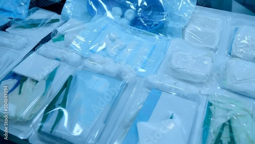 A set of materials for the treatment of wounds. Sterile disposable set with tray, power clip, gauze and cotton balls. Closeup. Shot in motion