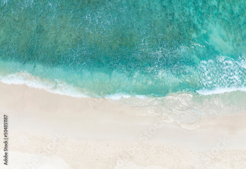 Aerial view of the tropical summer with Sea Waves Crashing on Shore and white sand beach