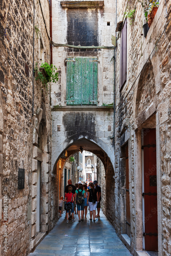 Old streets, architecture. Old facades and red tiled roofs. Vacation in the south of Europe. Exterior of buildings. Old style.