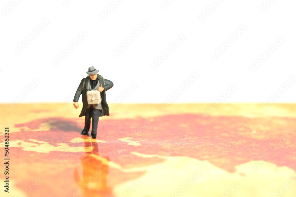 Obraz premium Miniature people toy figure photography. A man refugee walking above map, moving out from their country because of war conflict. Distance traveled concept