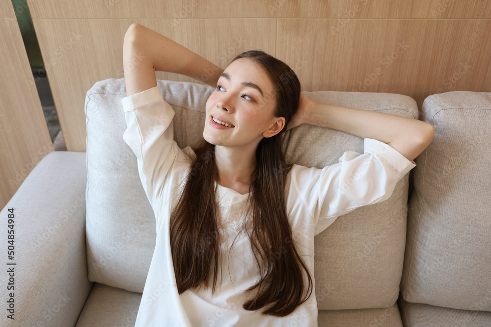 Portrait picture of Young Caucasian woman smile relax while lean and sleep on sofa bed Portrait picture of Young Caucasian woman smile relax while lean and sleep on sofa bed