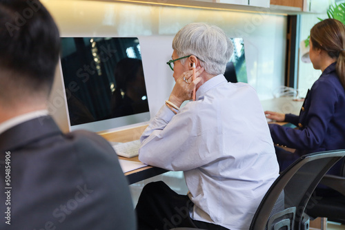 Group of business team sitting or working in office by using individual computer