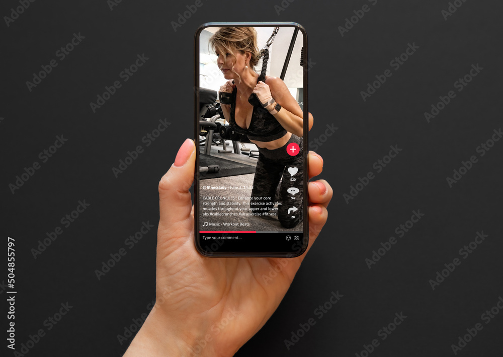 Video with a woman working out in a gym shared on social media app viewed on a mobile phone - obrazy, fototapety, plakaty 