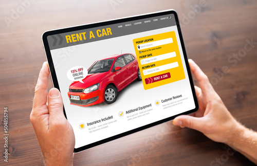Person looking at car rental website on tablet computer to rent a car