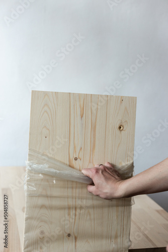 Removing the integral packaging from the furniture board.