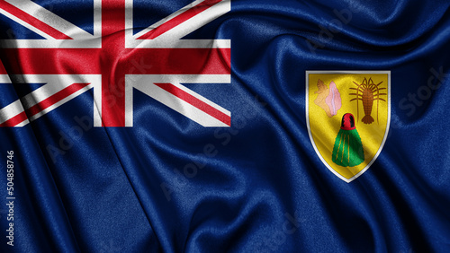 Close up realistic texture fabric textile silk satin flag of Turks and Caicos Islands waving fluttering background. National symbol of the country. Happy Day concept
