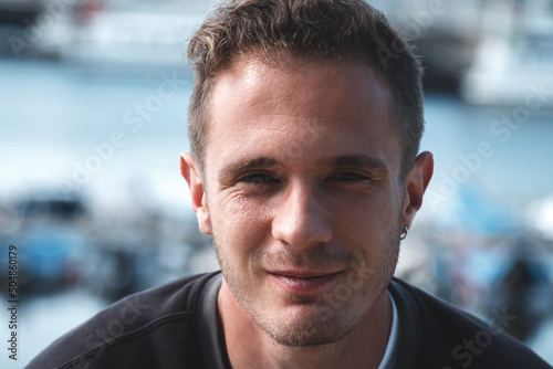 portrait of young tourist man with marina background