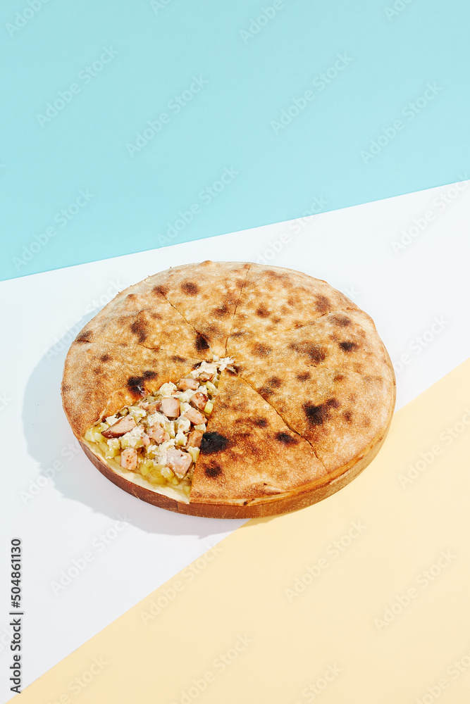 Italian closed pizza with cheese, potatoes and chicken on coloured  background. Chicken pie with cheese and potatoes in minimal style. American  pizza delivery concept with color backdrop. Photos | Adobe Stock