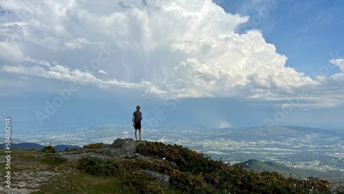 Man standing on top of the mountain relaxing and enjoying beautiful summer mountain landscape. A panoramic view of the Smoky Mountains Portugal . High quality photo © Oleksandra