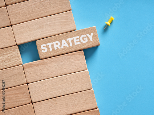 The word strategy written on wooden blocks. Choosing business strategy concept.