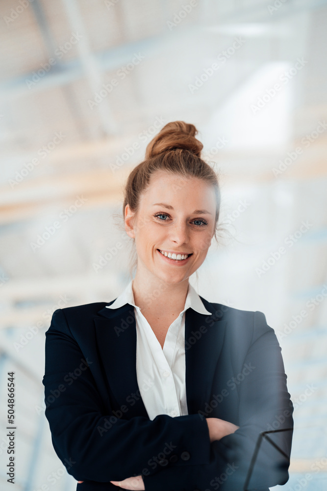 Smiling businesswoman with arms crossed at factory Smiling businesswoman with arms crossed at factory