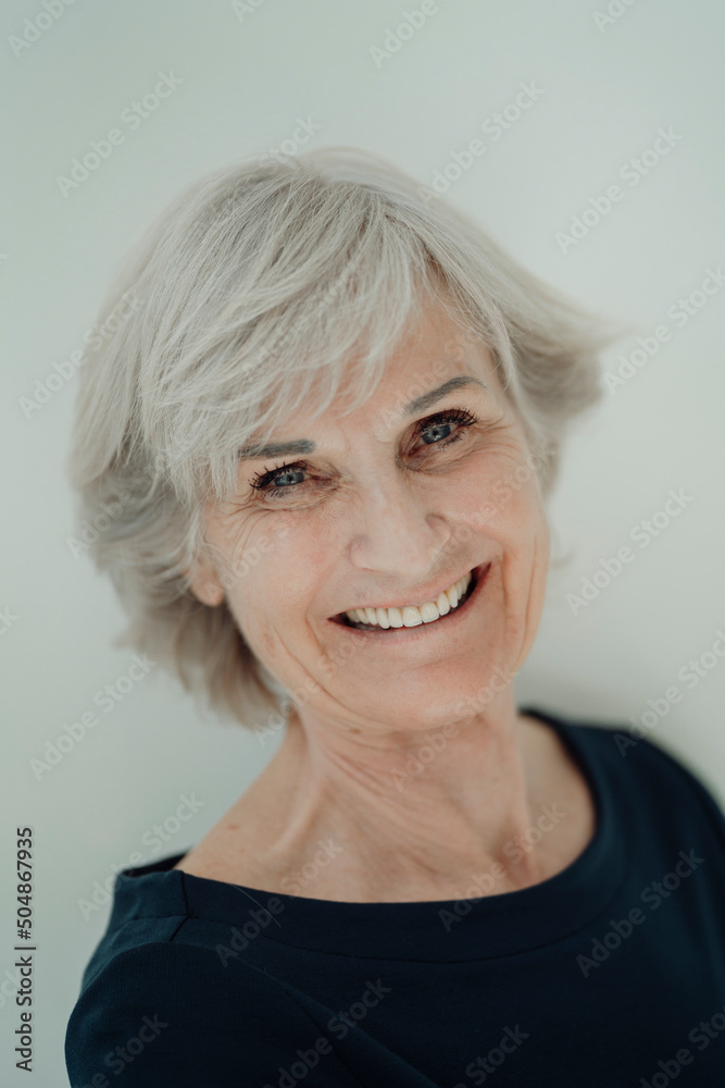 Happy senior woman with gray hair against white background Happy senior woman with gray hair against white background