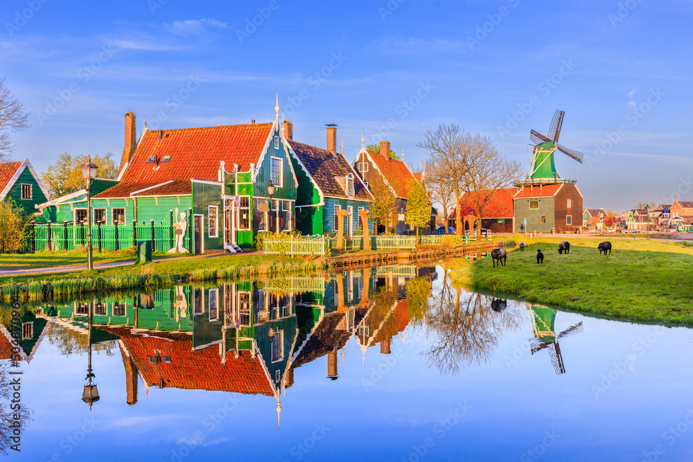 Zaanse Schans village, Netherlands. Dutch windmill and traditional house at sunrise.