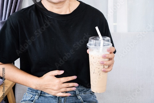 woman having stomachache after drinking coffee because of too much gastric acid in caffeine