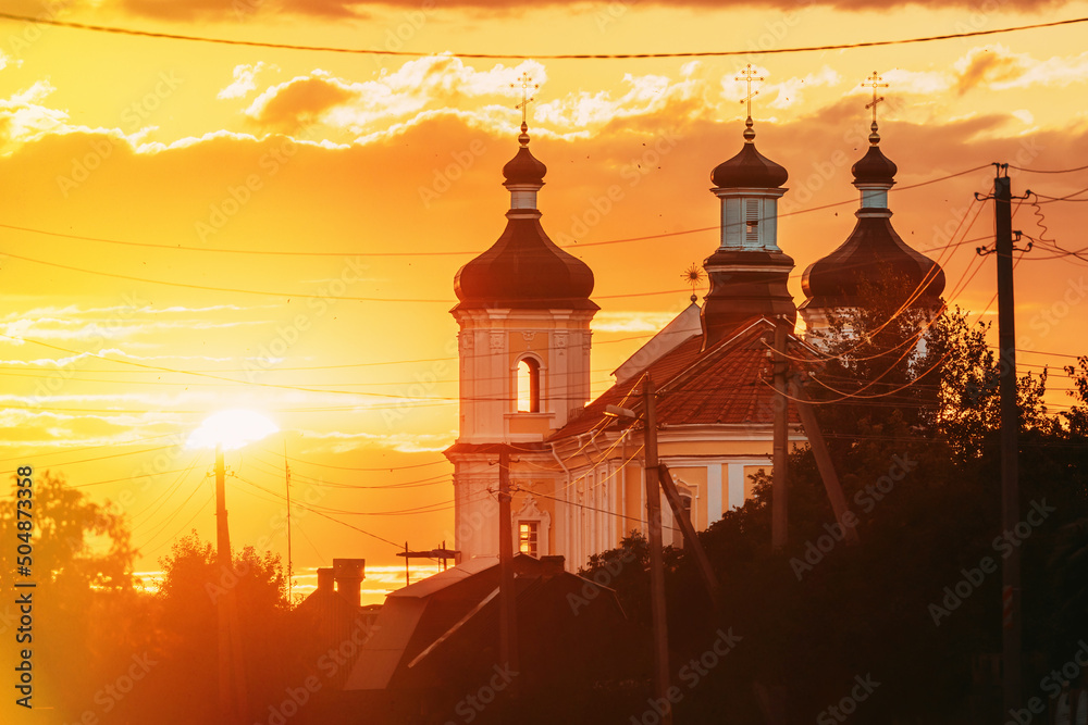Fototapeta premium Yurovichi, Belarus. , Big Sun Above Jesuit Collegium Complex. Yurovichi, Belarus. Big Sun Above Jesuit Collegium Complex