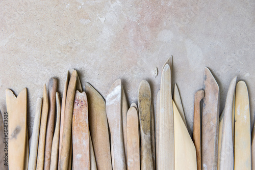 Fotografie Wooden pottery tools set on a ceramics studio background