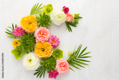 Composition of beautiful flowers, succulents and leaves on light background. Flowers frame.Top view, copy space. photo