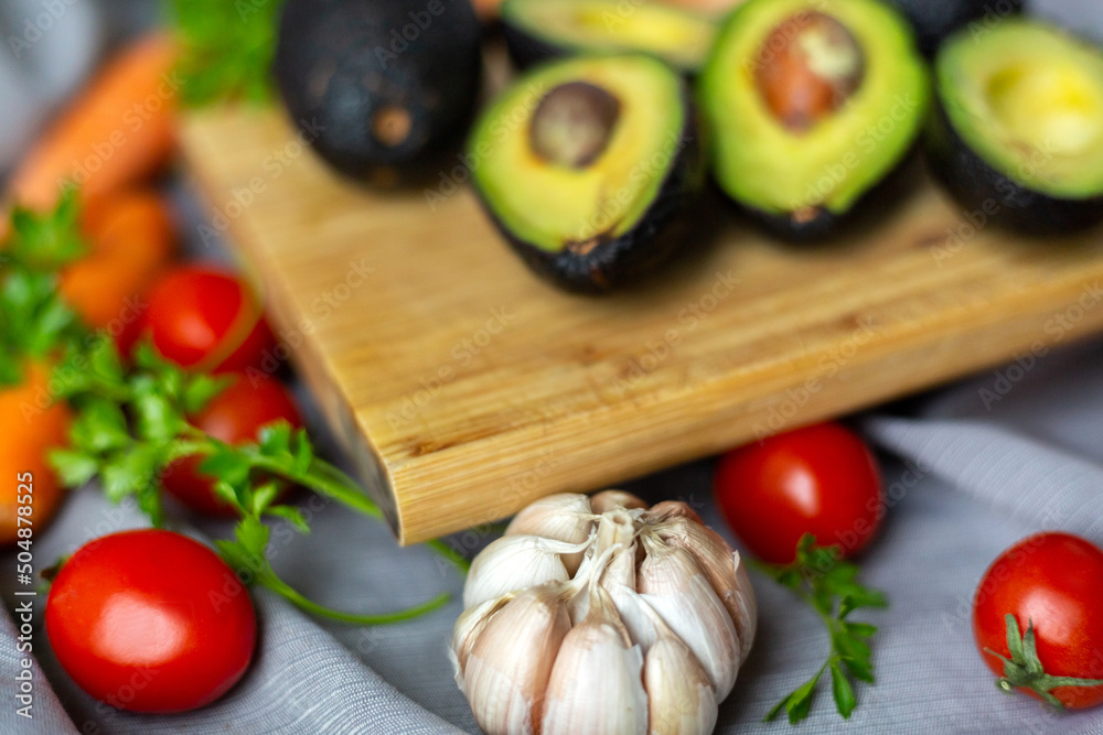 Close up avocado, isolated on white background with several vegetables. Close up avocado, isolated on white background with several vegetables.