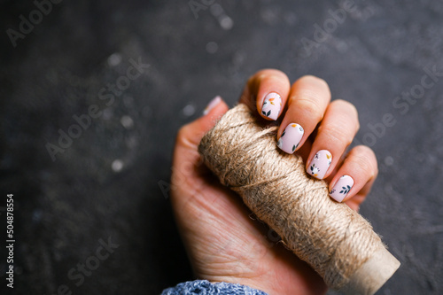 Luxury short manicure on a dark wooden background. cozy autumn nails. 
