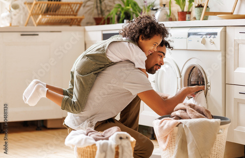 Father and son doing laundry together photo