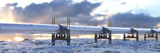 Large long distance gas and oil pipeline crossing through snow covered fields at sunrise 3d render