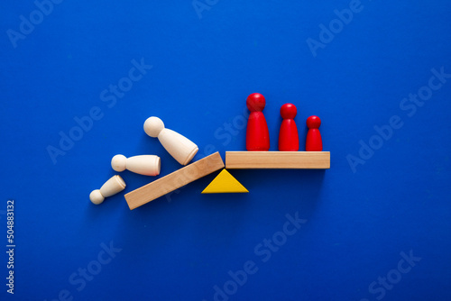 Team standing on a wooden seesaw, one side winner and one side loser. Success and failure. Business and workplace competition. Losers and winners.